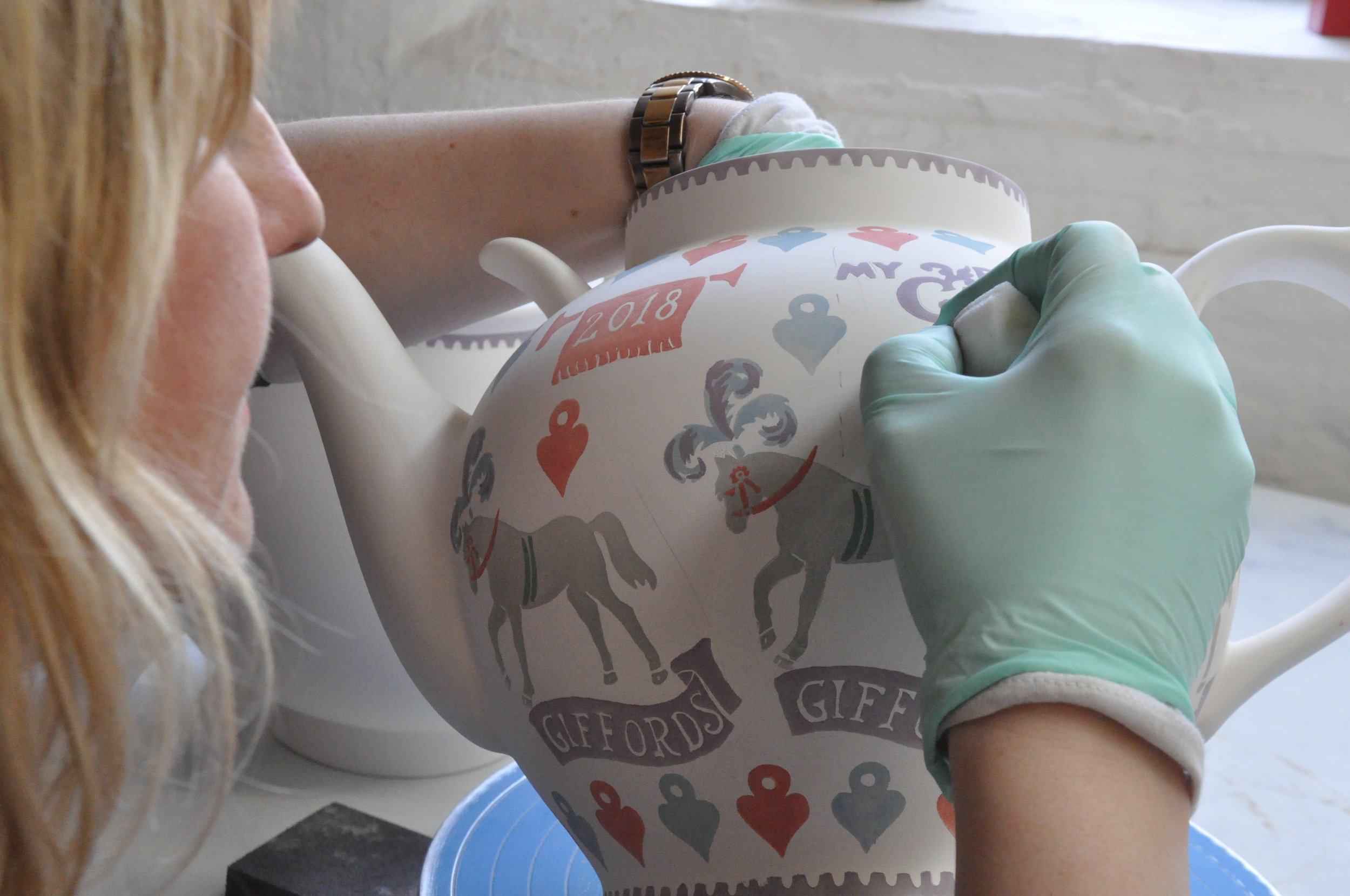 Senior decorator Lindsey, decorating our new Circus Sauce teapots