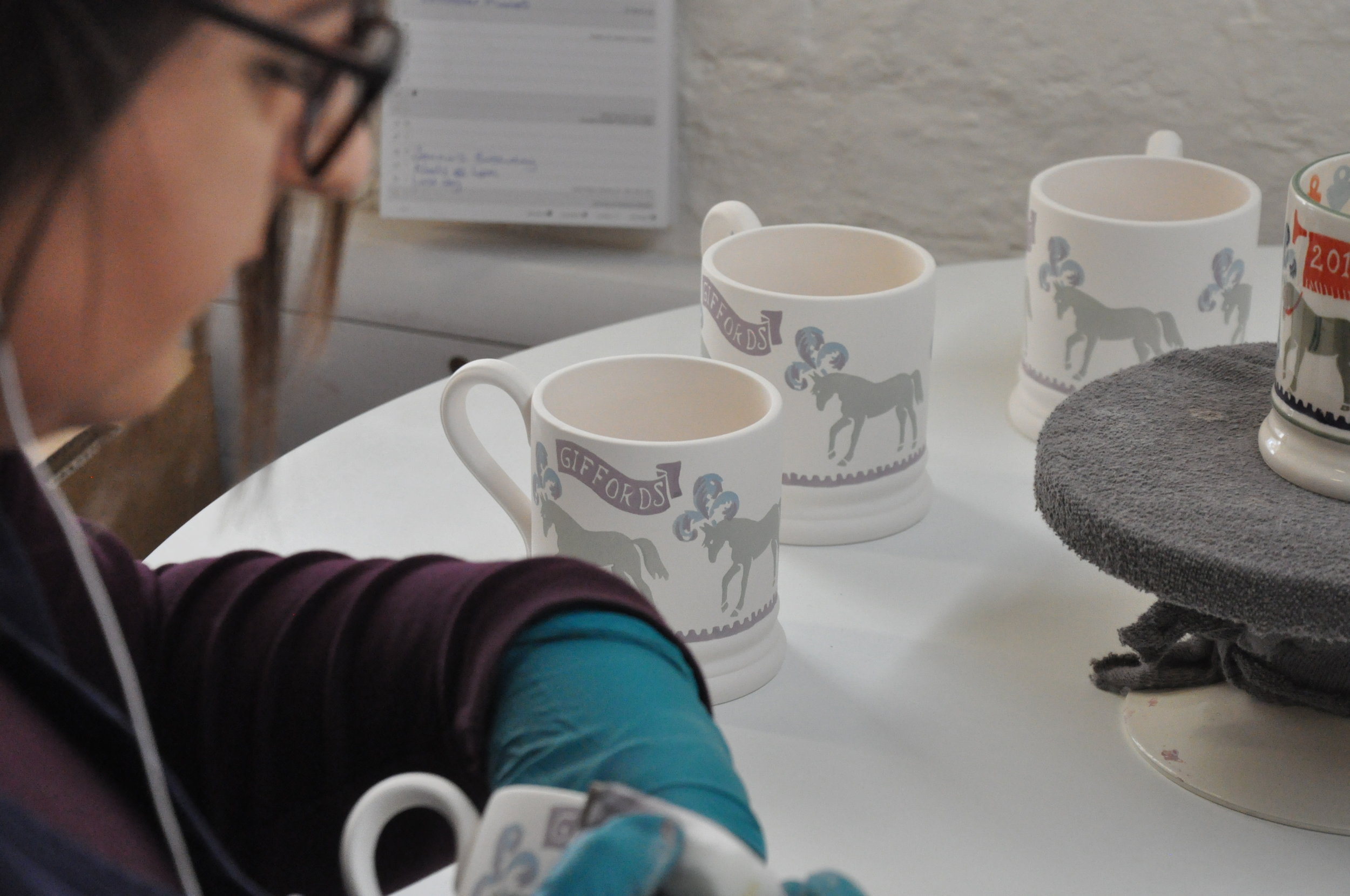  Charlotte decorating the 2018 mugs in the decorators studio  