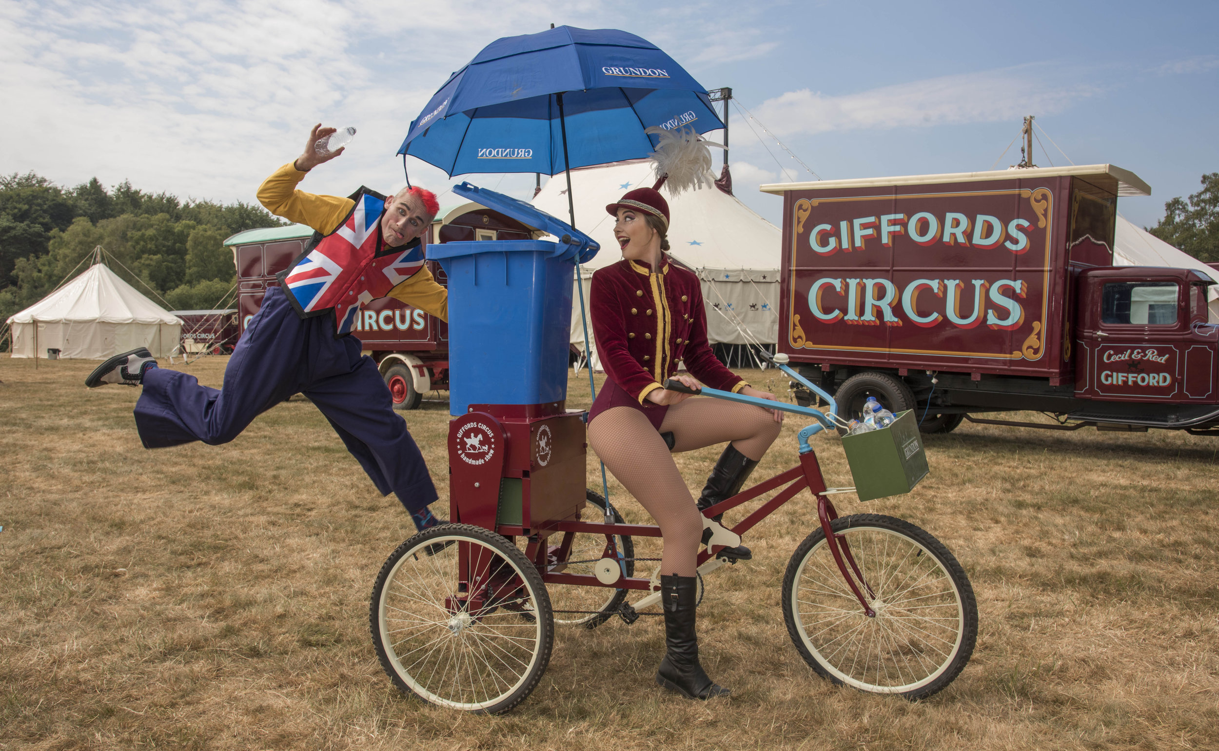 Tweedy the clown and showgirl Lizzie on the Recycle Bicycle