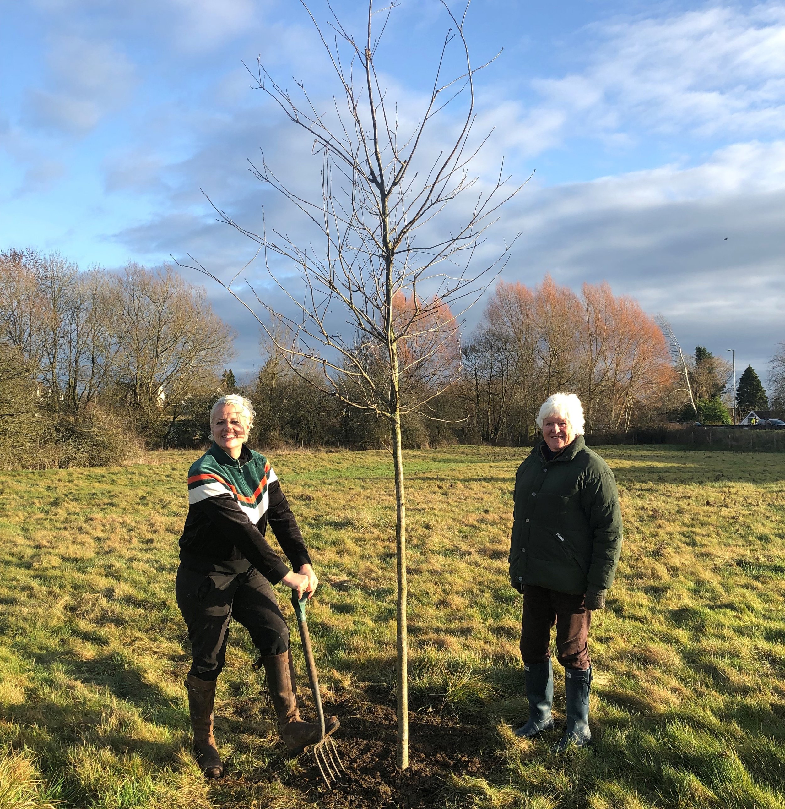 Nell Gifford planting an oak tree at Stratton Meadows with owner Sarah Holland